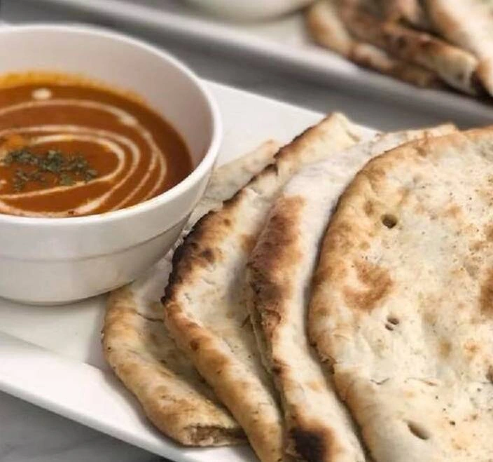 Butter chicken served with fresh naan bread at Ginger Indian Cuisine, Richmond BC